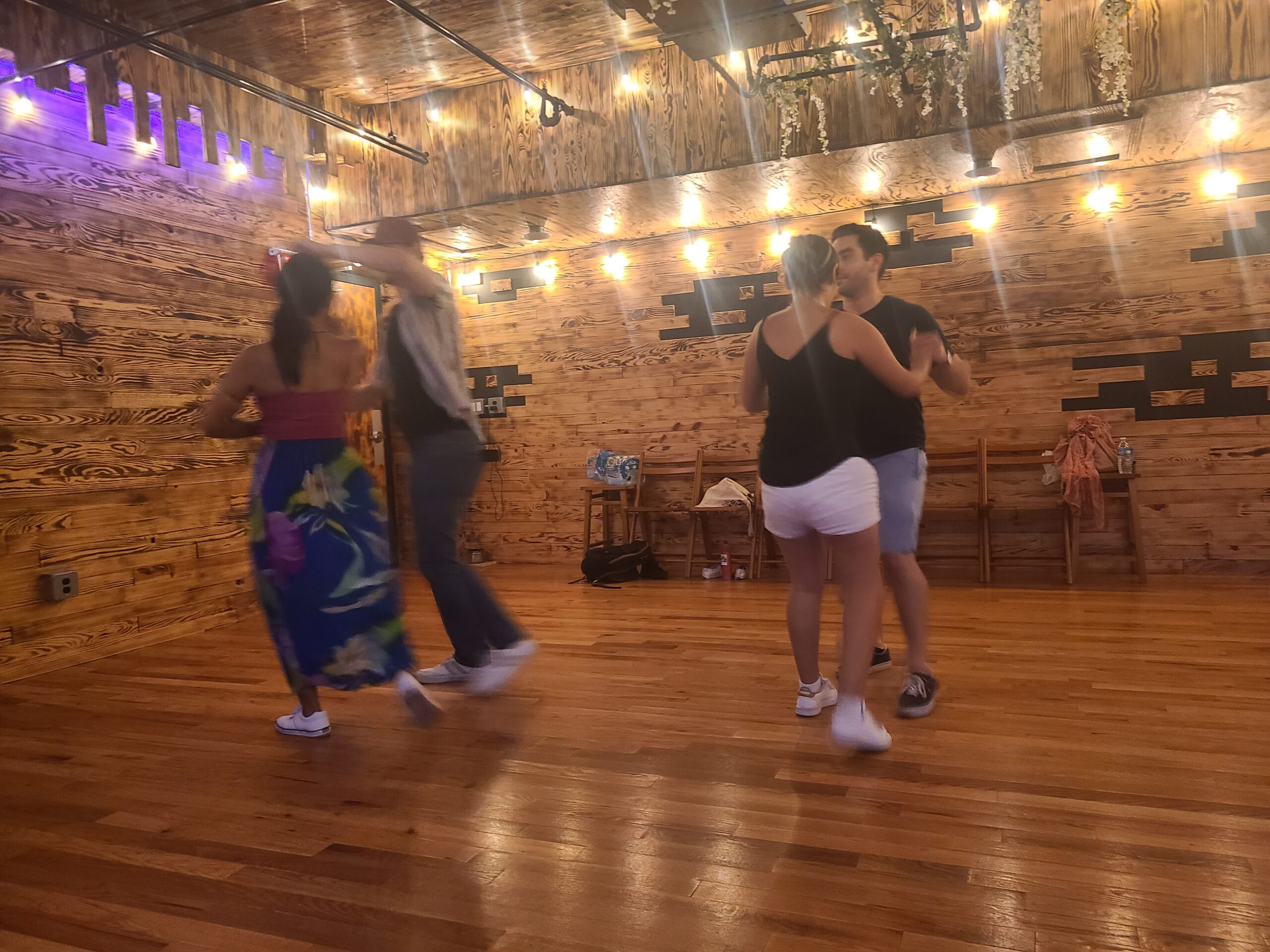 two couples dancing during salsa classes